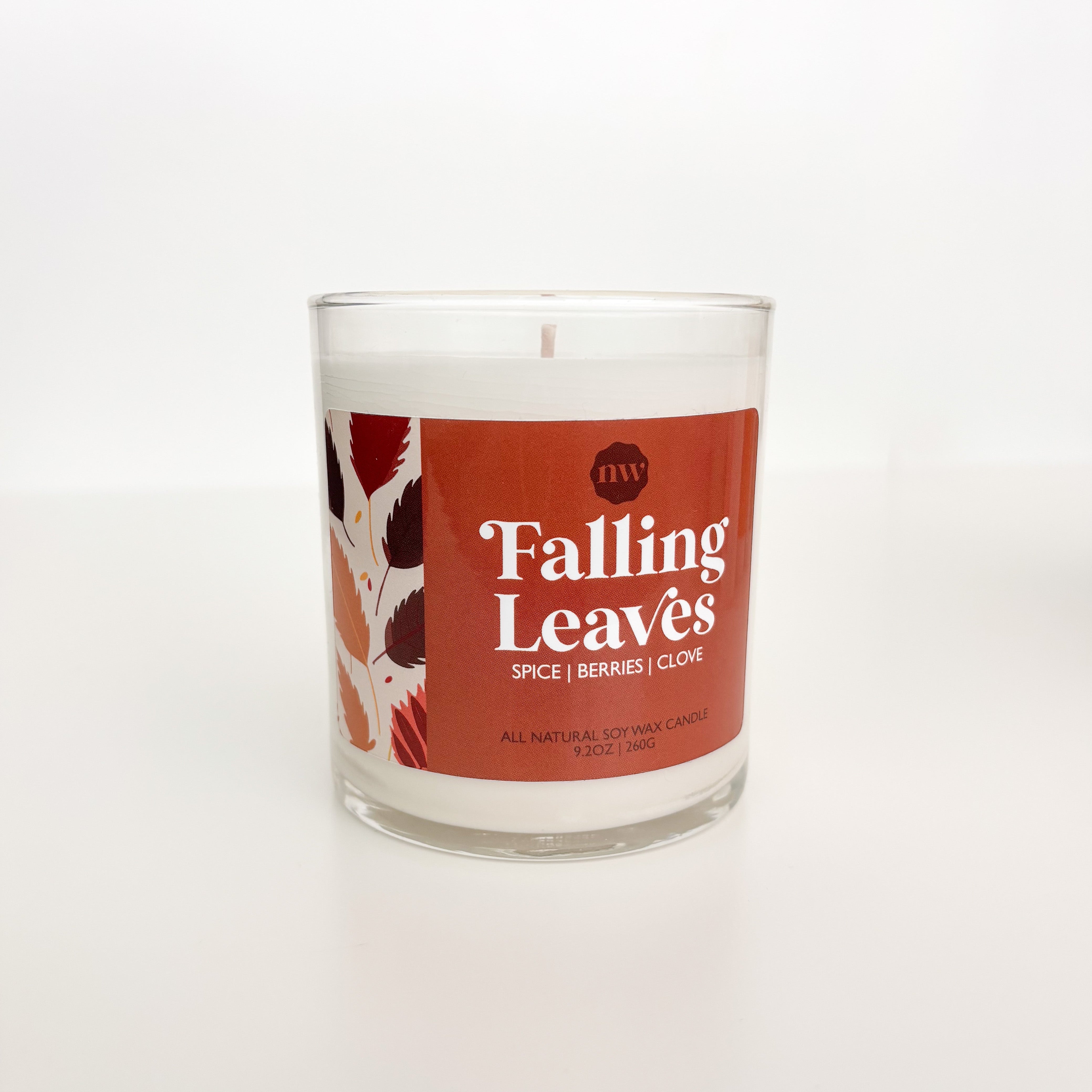 Candle with 'Falling Leaves' label on a white background